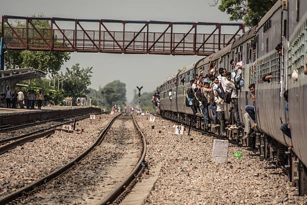 train passengers hanging on